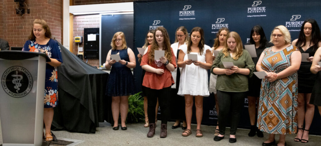 Instructional Technologist Jennifer Smith was chosen by the new graduates to lead them in reciting the Veterinary Technician Oath of Ethical Conduct at the Graduation Celebration and Oath Ceremony in Lynn Hall.