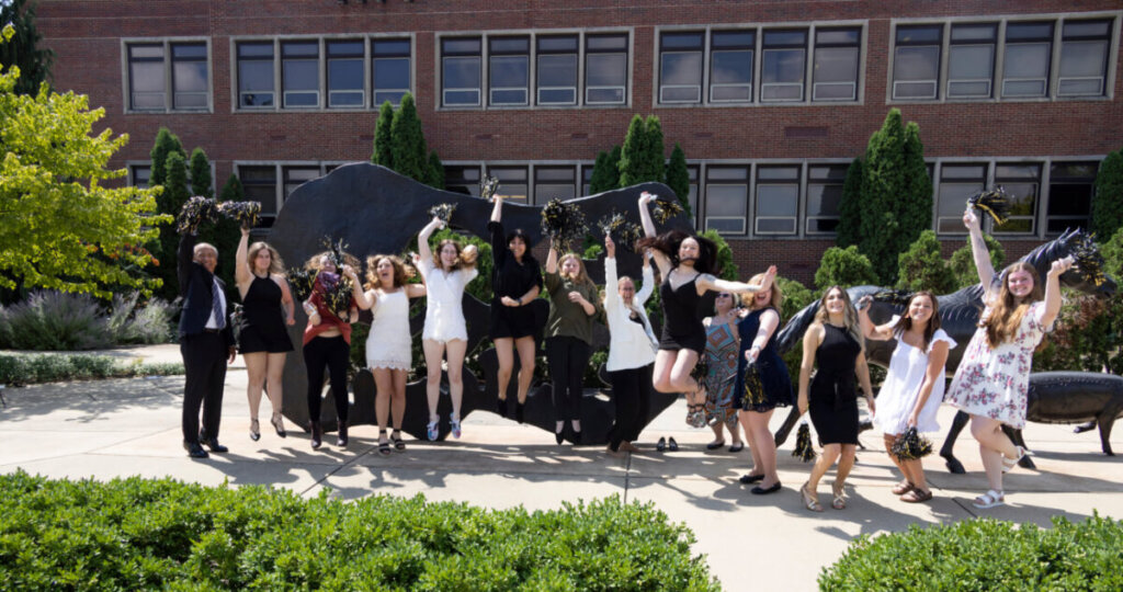 Associate in Applied Science in Veterinary Nursing graduates in the Class of 2022 celebrate with dean Reed in front of the Continuum Sculpture after commencement ceremonies August 6.