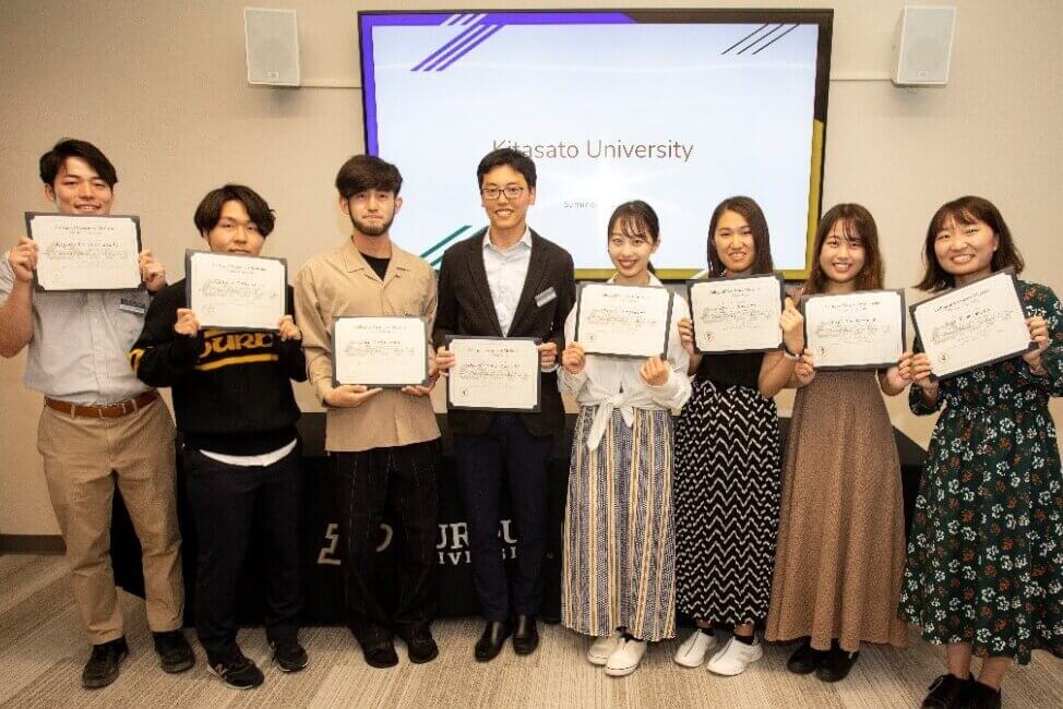 Kitasato University students and their faculty advisor (center), Dr. Kazuki Tajima, display the certificates they received at the farewell reception held in the David and Bonnie Brunner Small Animal Hospital.  