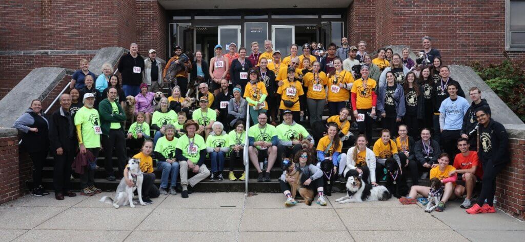 Dog Jog participants gathered with members of Dr. Skip Jackson’s family for a commemorative group photo in front of Lynn Hall after the race.