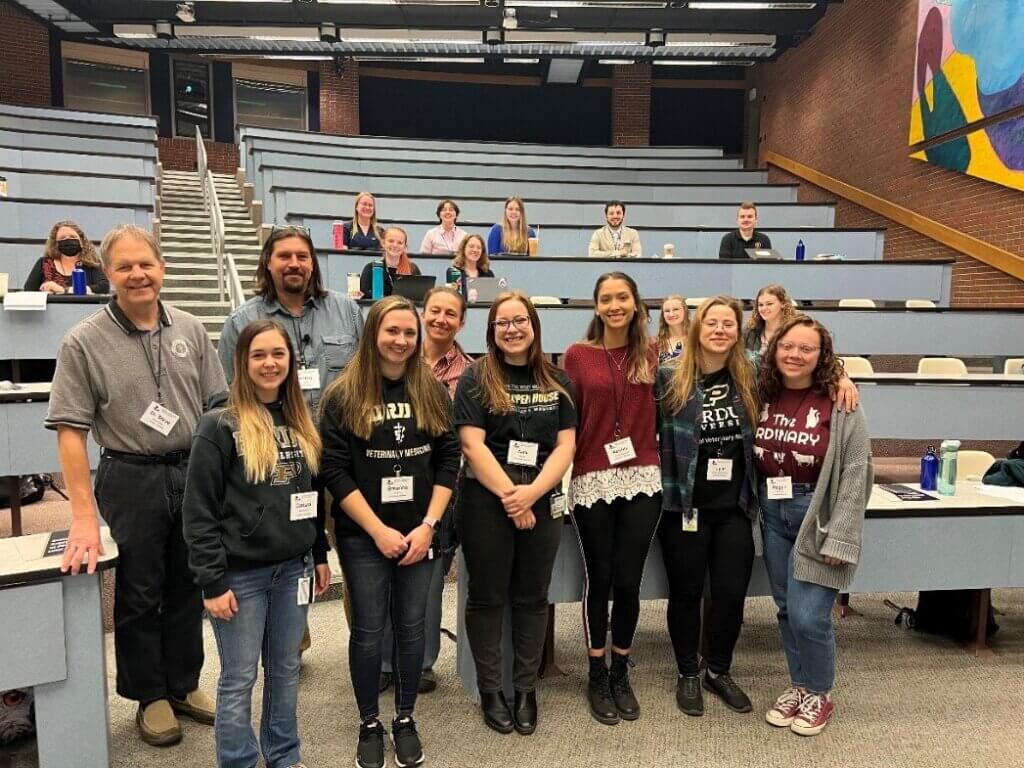 MMAS volunteers from the Exotic Animal Club (front, left-right) Carissa Adrianson, Breanna Davis, and Alex Meyer, all of the DVM Class of 2025, and Keishla Marrero Acosta, Taylor Fidler-Jarzyniecki, and Maggie Pritchett, of the DVM Class of 2024, with (back row) Dr. Steve Thompson, Exotic Animal Club faculty advisor, and keynote speakers Anton Vaidl and Dr. Helena Vaidlová.