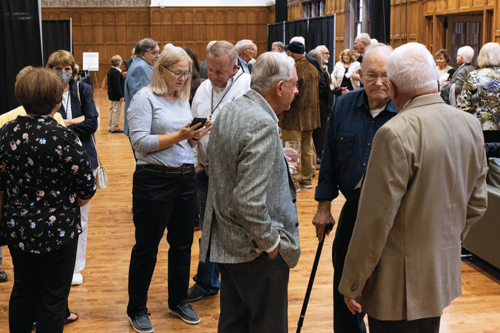 Conference goers mix and mingle in the Exhibit Hall