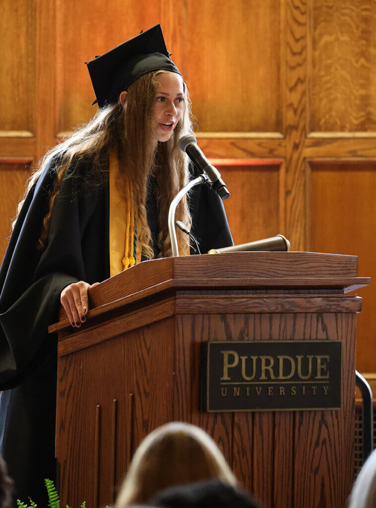 Brooke speaks to the graduating class and family and friends in attendance during the college's graduation celebration