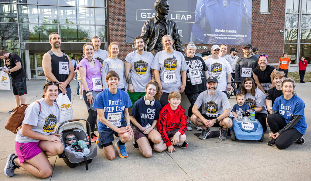 The Purdue Veterinary Medicine group join together for a group photo in front of the Neil Armstrong sculpture on Purdue's campus.