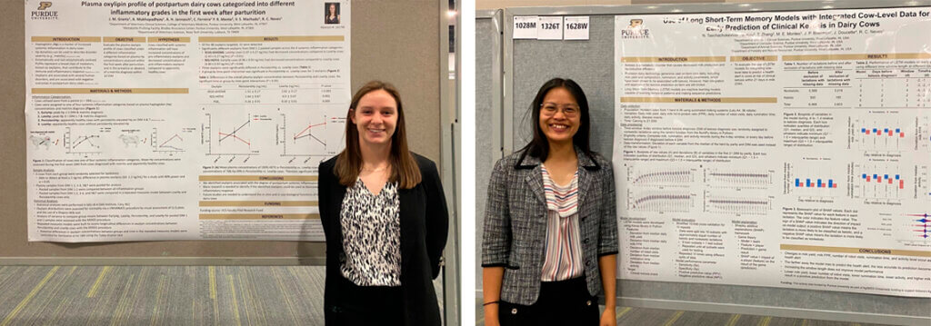 Jillian and Natnicha stand smiling beside their respective research posters displayed at the event