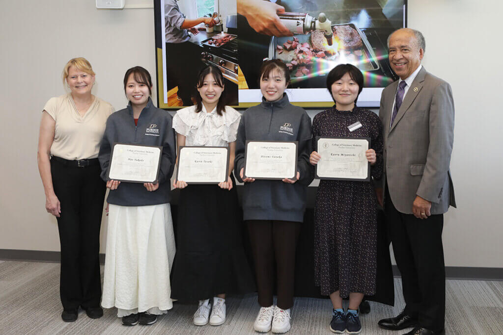 Kitasato students are joined by Dean Reed and Dr. Salisbury as the students hold up their exchange program completion certificates