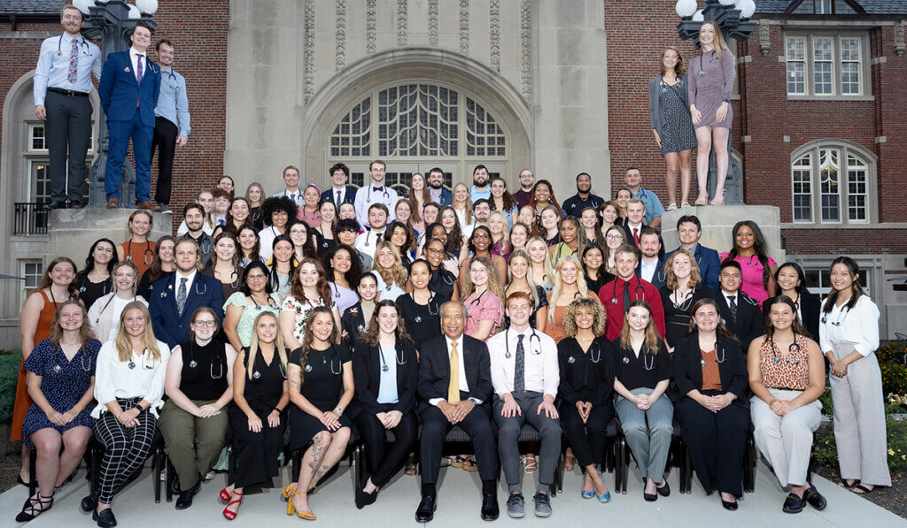 DVM students gather in rows on the steps of the Purdue Memorial Union with Dean Reed seated in the middle of the front row