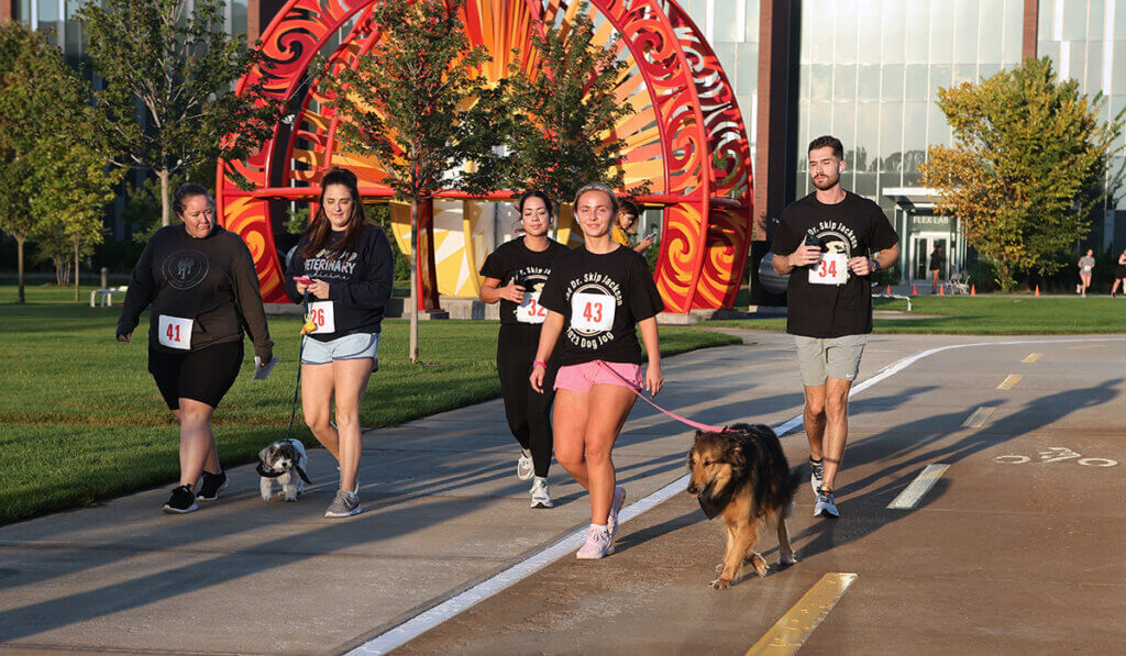 Dog Jog participants walk past the solar system installation on Purdue's campus.