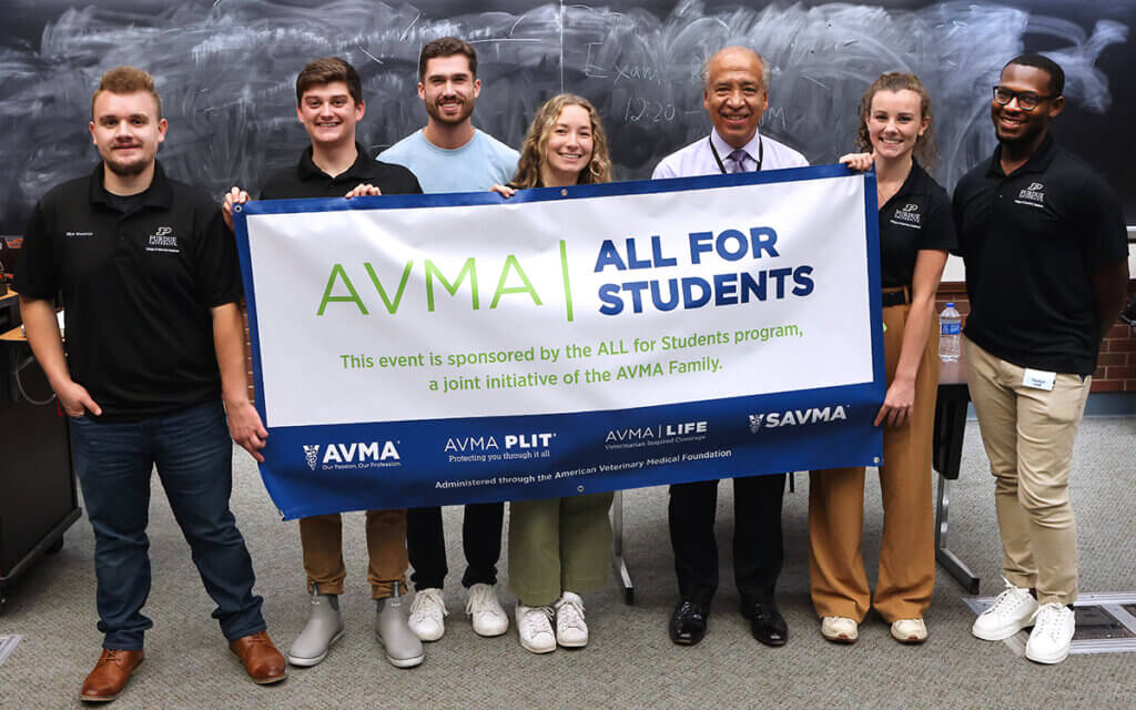 SAVMA leadership and Dean Reed stand behind a banner for AVMA All for Students