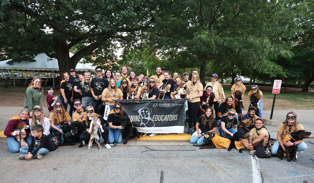 The PVM group gather for a group photo decked out in superhero masks and capes for the Homecoming parade