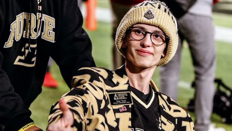 Tyler is shown smiling decked out in Purdue gear