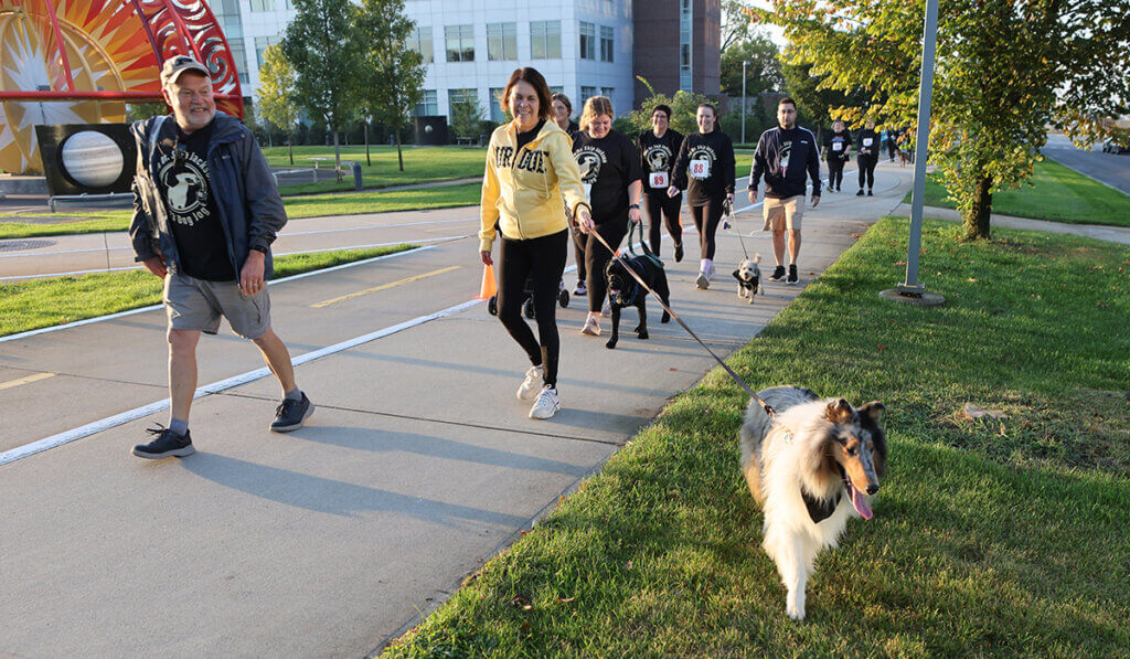 Dog Jog participants pass the solar system installation on Purdue's campus