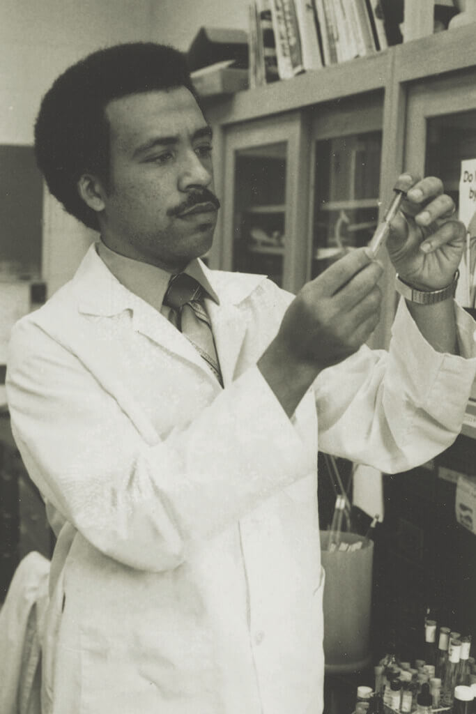 Dean Reed works in a lab early in his career