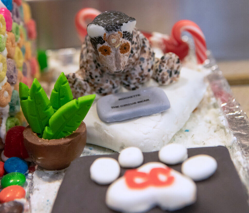 A close-up of Rockette the Circus Bear statue as part of the gingerbread decor