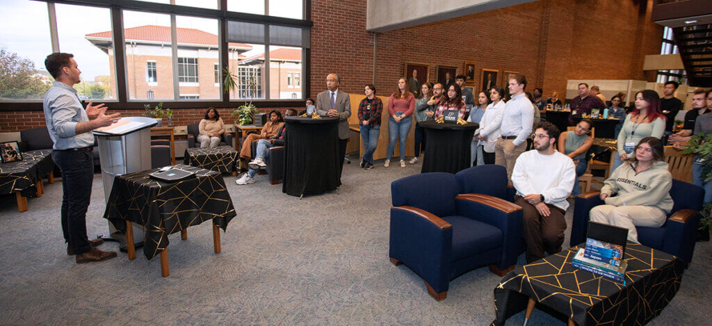 Addison shares remarks with the group at the Global Engagement Fair in the library.