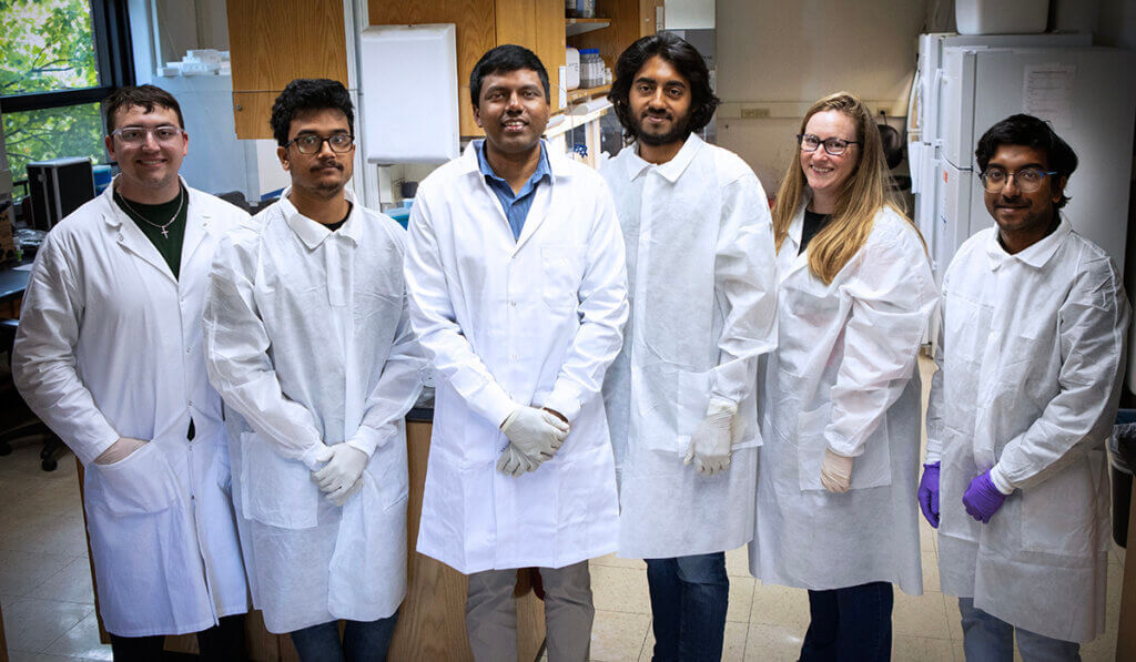 Dr. Thangamani and his lab team join together for a photo in his lab