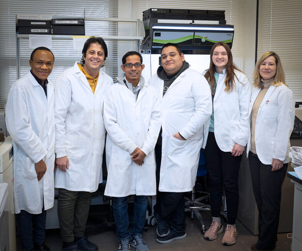 Dr. Fortin and members of her lab team join together for a group photo in her lab