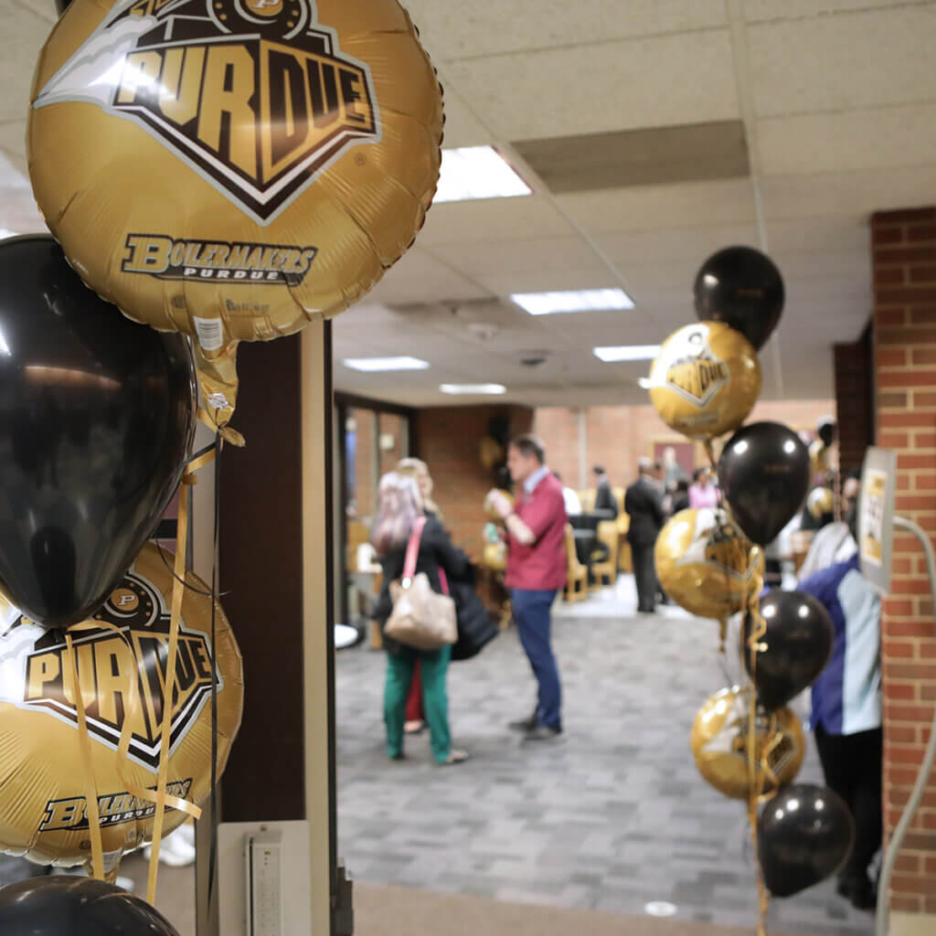 Balloons decorate the entrance to the library where prospective students and their guests mingle with college faculty and students