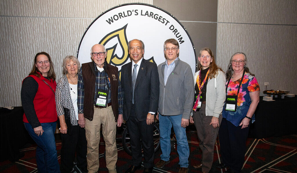 Dr. Shafer and his family in attendance join the dean in front of the Purdue drum at the reception