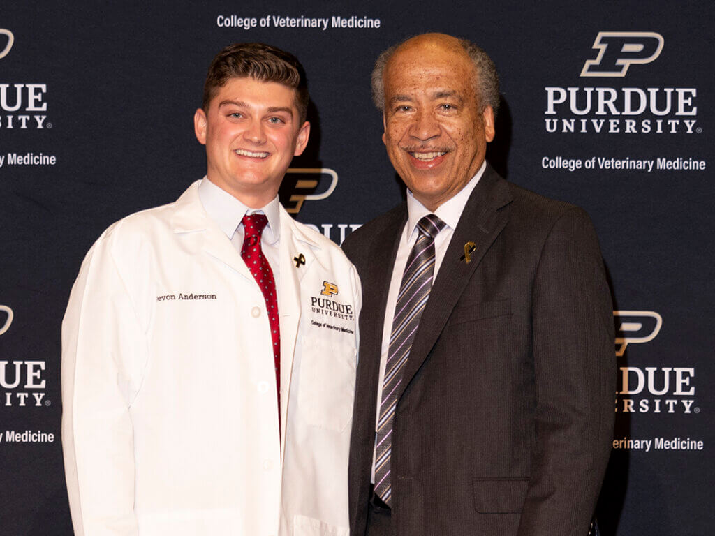 Devon Anderson with Dean Reed after receiving his white coat. He also was recognized for his service during the past year as president of SAVMA Purdue.