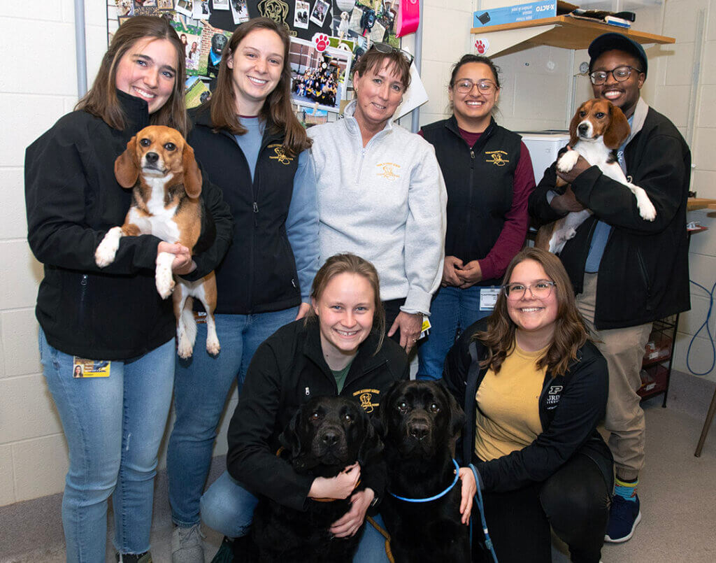 the Canine Educator Care Team poses for a photo with dogs