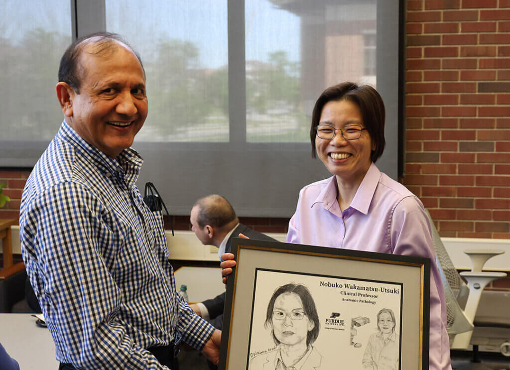 Dr. Suresh Mittal congratulates his departmental colleague, Dr. Nobuko Wakamatsu-Utsuki, on her promotion to clinical professor of comparative pathobiology.