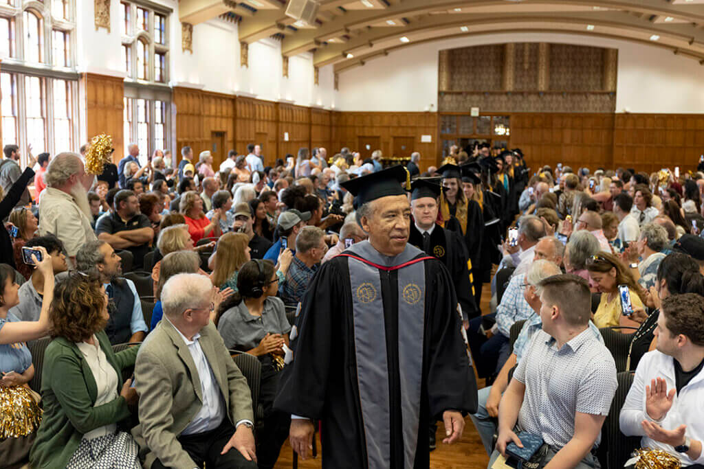 Dean Willie Reed leads the processional through the PMU Ballrooms at the start of the PVM Graduation Celebration.