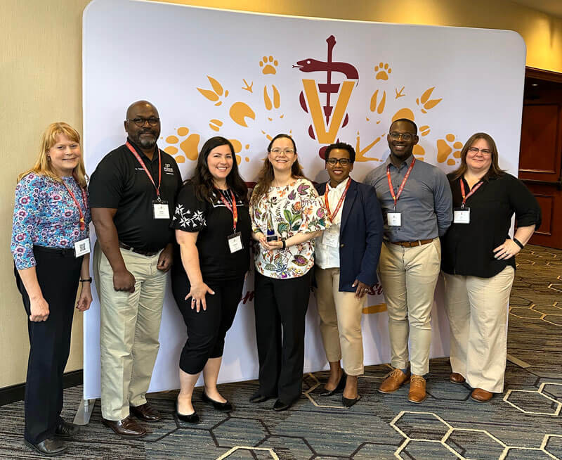 The recipient of the Zoetis Diversity and Inclusion Award, Dr. Marxa Figueiredo (center) with several PVM representatives at the Iverson Bell Midwest Regional Diversity Summit in Minneapolis (left-right): Dr. Kathy Salisbury, Dr. Darryl Ragland, Adrianne Fisch, Marsha Baker, Kyle Barron and Joy Nix.
