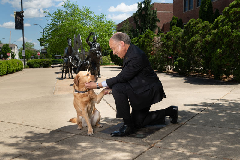 Bueller, one of the college’s friendly Canine Educators, joins Dean Reed for a promotional photo shoot for the podcast.