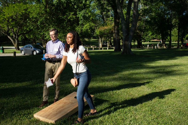 Gabrielle Bressler of the Purdue DVM Class of 2026 and Associate Dean for Research Harm HogenEsch demonstrate exemplary concentration as they teamed-up for a game of cornhole.