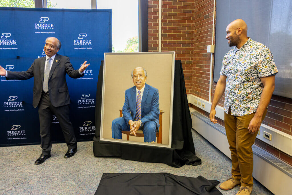 Dean Reed acknowledges the beautiful artistry of Patrick Hammie, who painted the dean’s portrait, and helped unveil it at the reception.