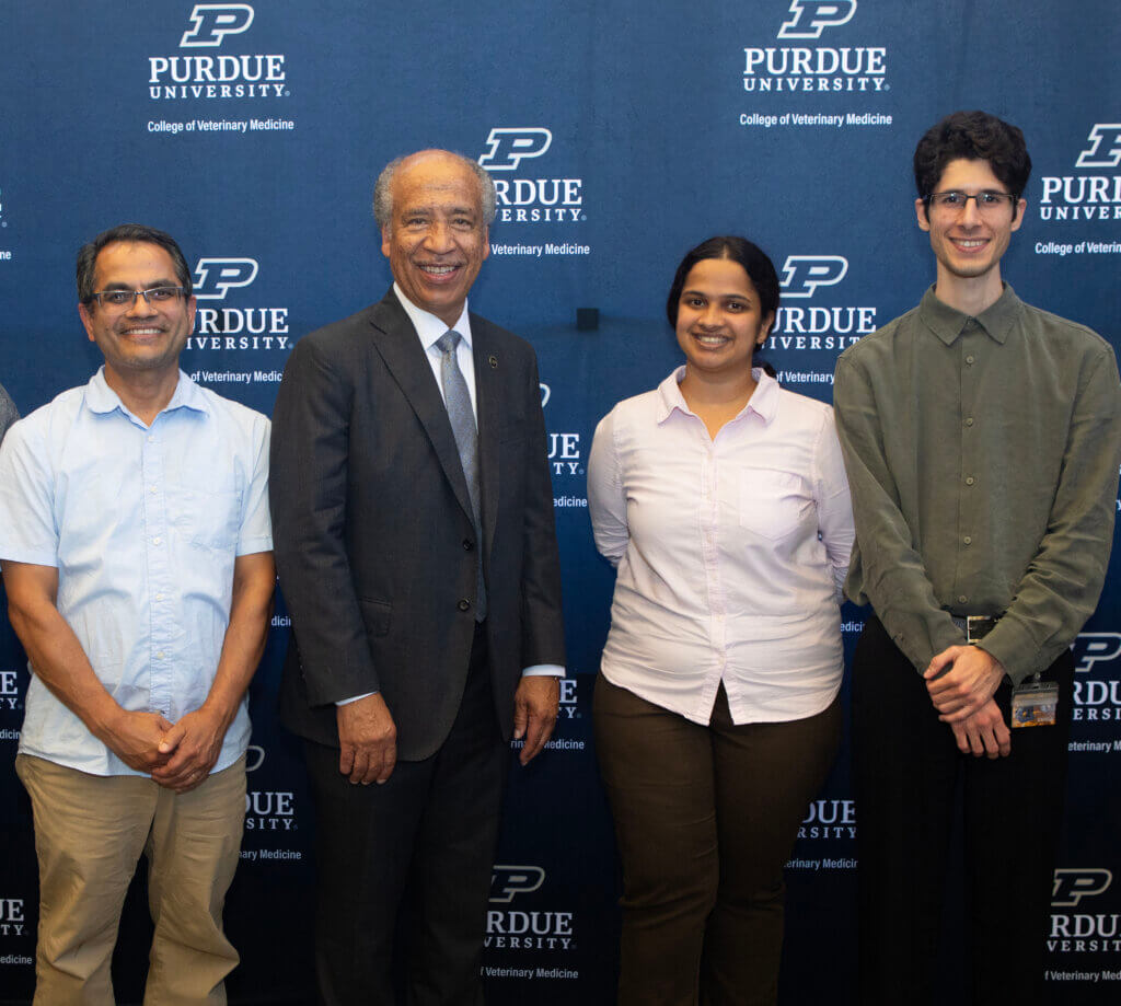 Purdue Veterinary Medicine Dean Emeritus Willie Reed with Uma Aryal and his graduate students, Punyatoya Panda and Rodrigo Mohallem.