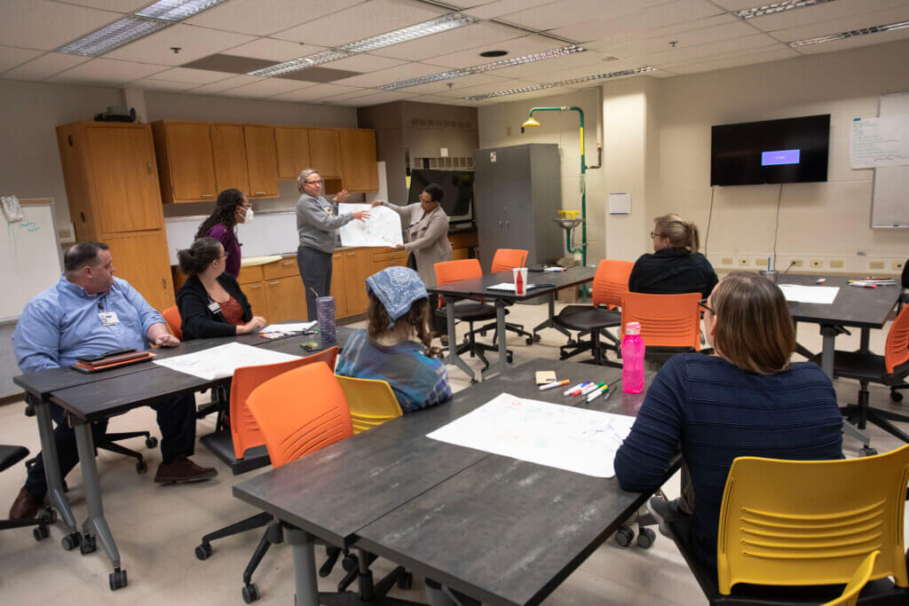 During the visioning workshops, attendees got into groups to draw simple illustrations of ideas and themes they wanted to suggest for the mural.