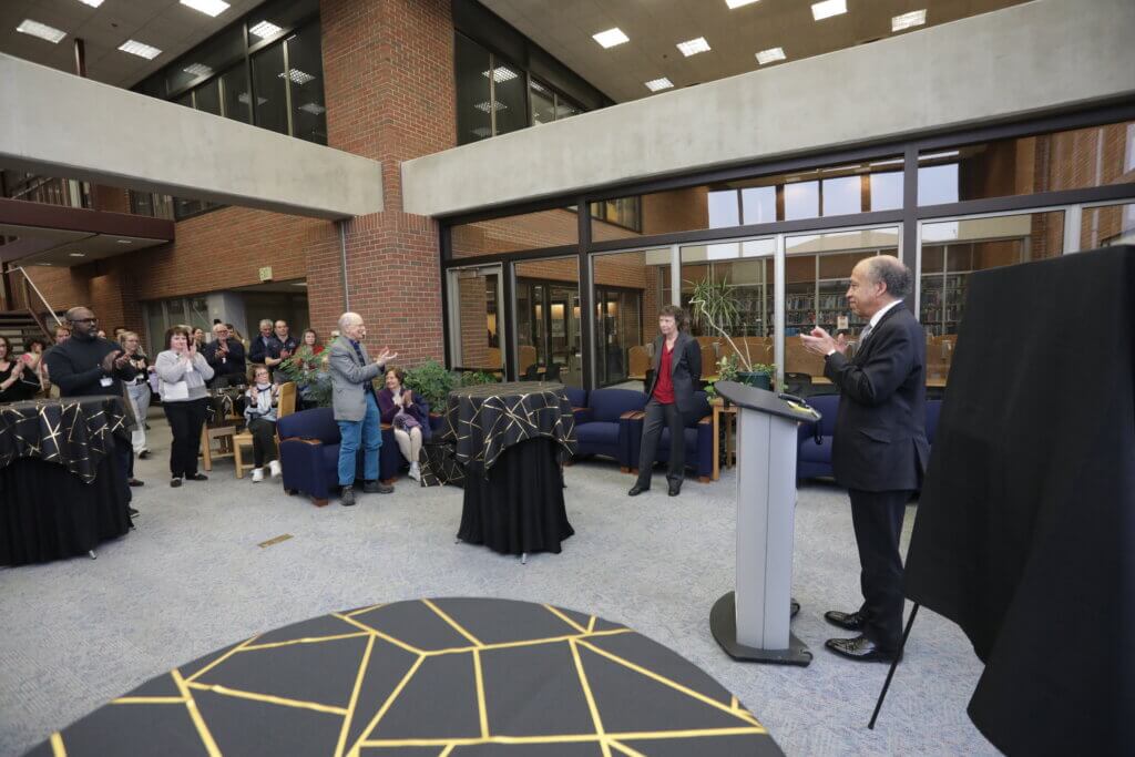 Faculty, staff and students applaud Dr. Laurie Jaeger at a reception held in her honor March 1 in the Veterinary Medical Library, as she stepped down as head of the Basic Medical Sciences Department.