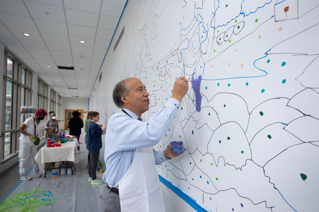 Dean Reed served as one of the volunteers for the initial mural painting, which involved a “paint-by-numbers” approach, with colored dots indicating the color to use for each section.