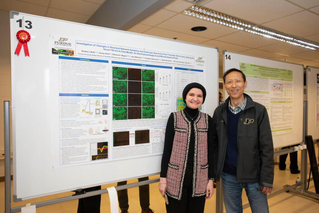 Shatha Mufti, a PhD student in the Interdisciplinary Biomedical Sciences Program, with her faculty mentor, Dr. Riyi Shi, and her 2nd place prize winning poster in the Basic Research category.