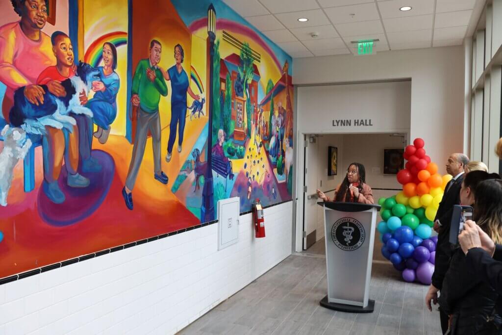 Artist Tia Richardson shared about the mural she created for the College of Veterinary Medicine, with input from faculty, staff and students, during the mural dedication ceremony April 26.