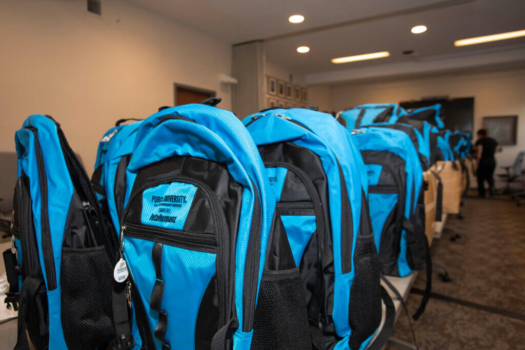 During volunteer works sessions in Lynn Hall, a total of 500 backpacks were prepared so they could be delivered to Miller Elementary School – enough for every Miller Elementary student to receive one.