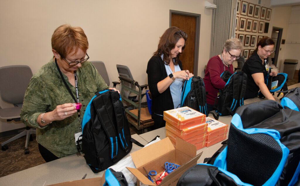 Volunteers participating in PVM Cares! filled 500 backpacks with homework supplies – enough for every Miller Elementary student to receive one.