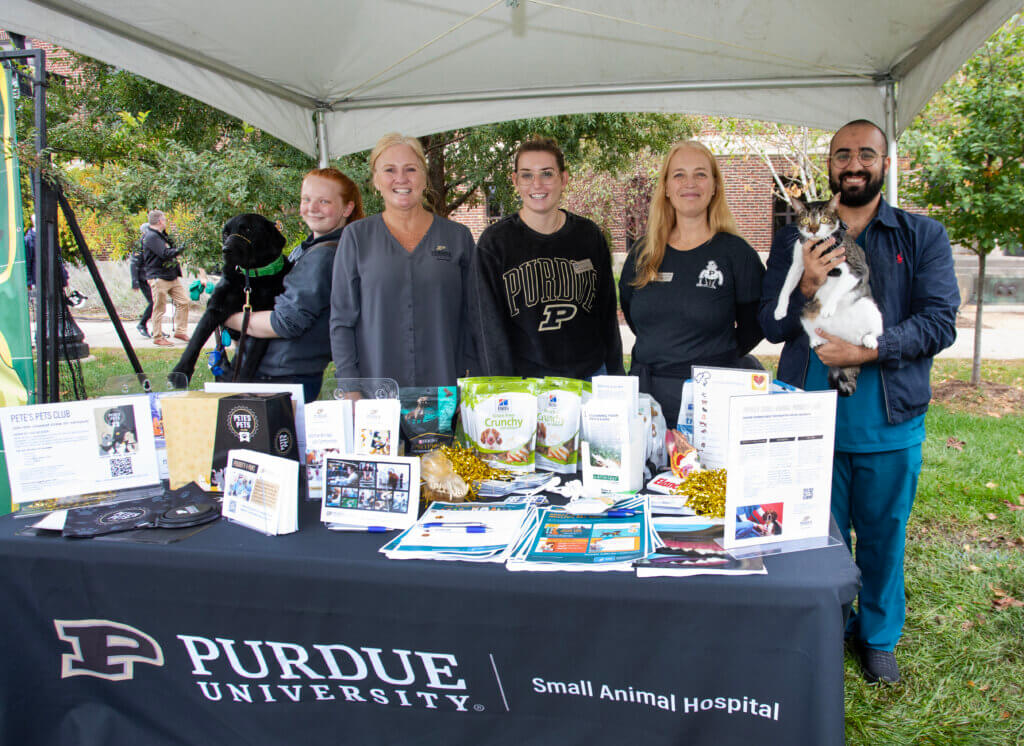 Small Animal Team from Purdue Veterinary Medicine standing at their booth at 2024 Homecoming festivities