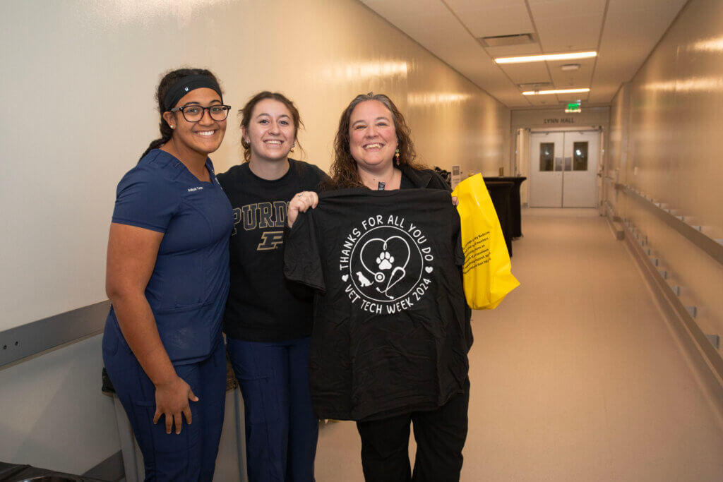 Instructional Technologist Jeannine Henry, RVT, displays her new Vet Tech Week T-shirt, complements of the Veterinary Nursing Student Organization (VNSO), as she is accompanied by VNSO President Aaliyah Turner (left) and VNSO fourth-year rep. Kylee Reinhardt.