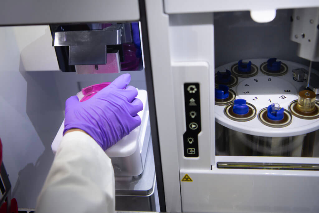 Sharath Iyengar, Basic Medical Sciences Department postdoctoral research associate, prepares a sample plate for testing, using the specially designed spectral cell sorter in a research laboratory in the College of Veterinary Medicine. (Purdue University photo/John Underwood)