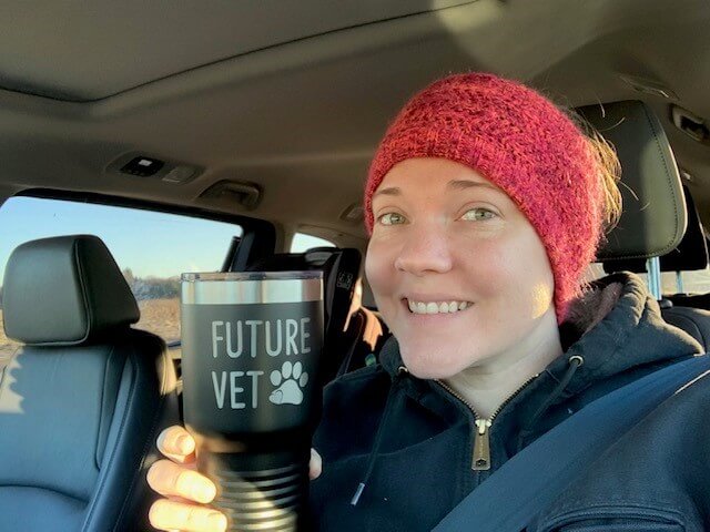 Sharon Meoli, fourth year DVM student, holding a cup that says "Future Vet"