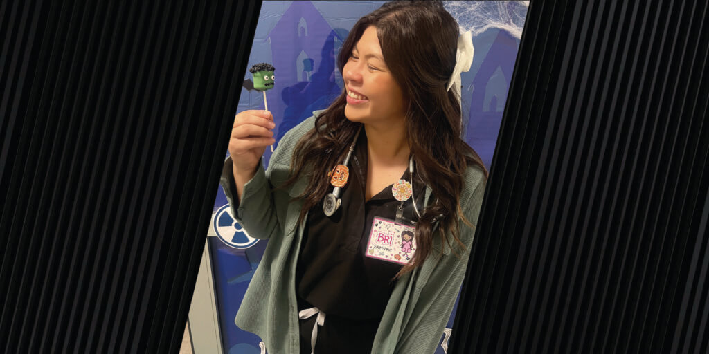 Small Animal Internal Medicine Veterinary Technologist Bri Kerr, RVT, holds one of her Franken Pops that won the top prize in the Best Design category of the Halloween Dessert Baking Contest.