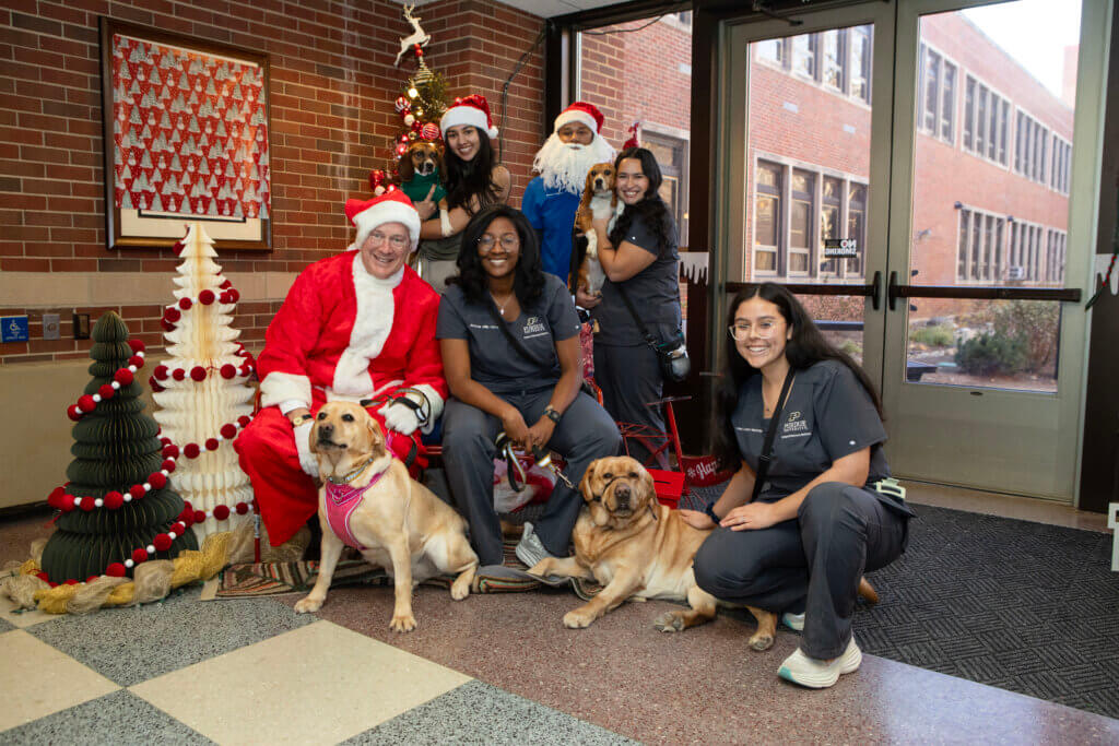 Canine Educators set the example for how to behave when having your photo taken with Santa! (Children take note!)