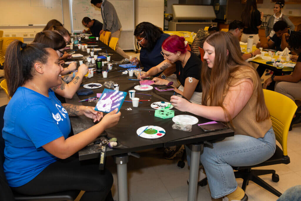 DVM students share their creativity as they paint their tiles as part of the Class Mosaic activity.