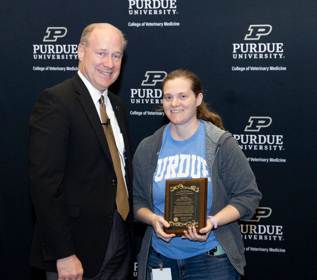 Dean Marsh presents an Outstanding Staff Award to Angie Chan, molecular laboratory supervisor in the Animal Disease Diagnostic Laboratory.