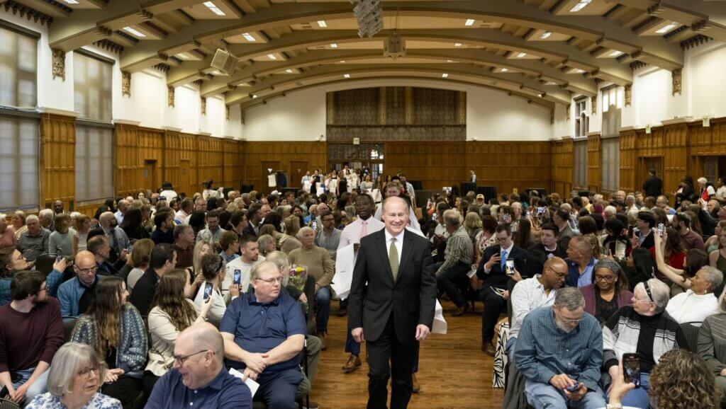 Dean Bret Marsh leads the members of the Class of 2026 through the Purdue Memorial Union ballrooms at the start of the White Coat Ceremony.