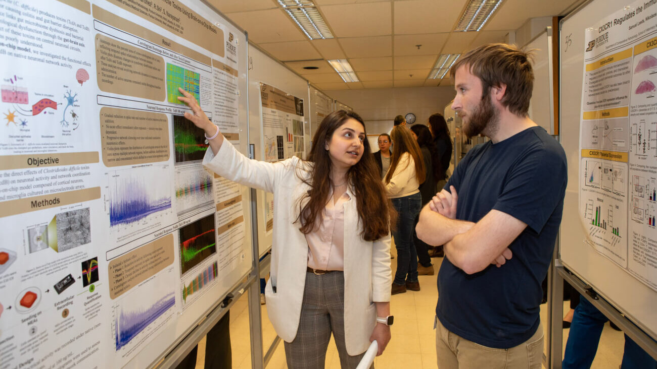 Department of Comparative Pathobiology Graduate Research Assistant Niloufar Ghahari discusses her prize-winning research poster during the PVM Research Day poster session.