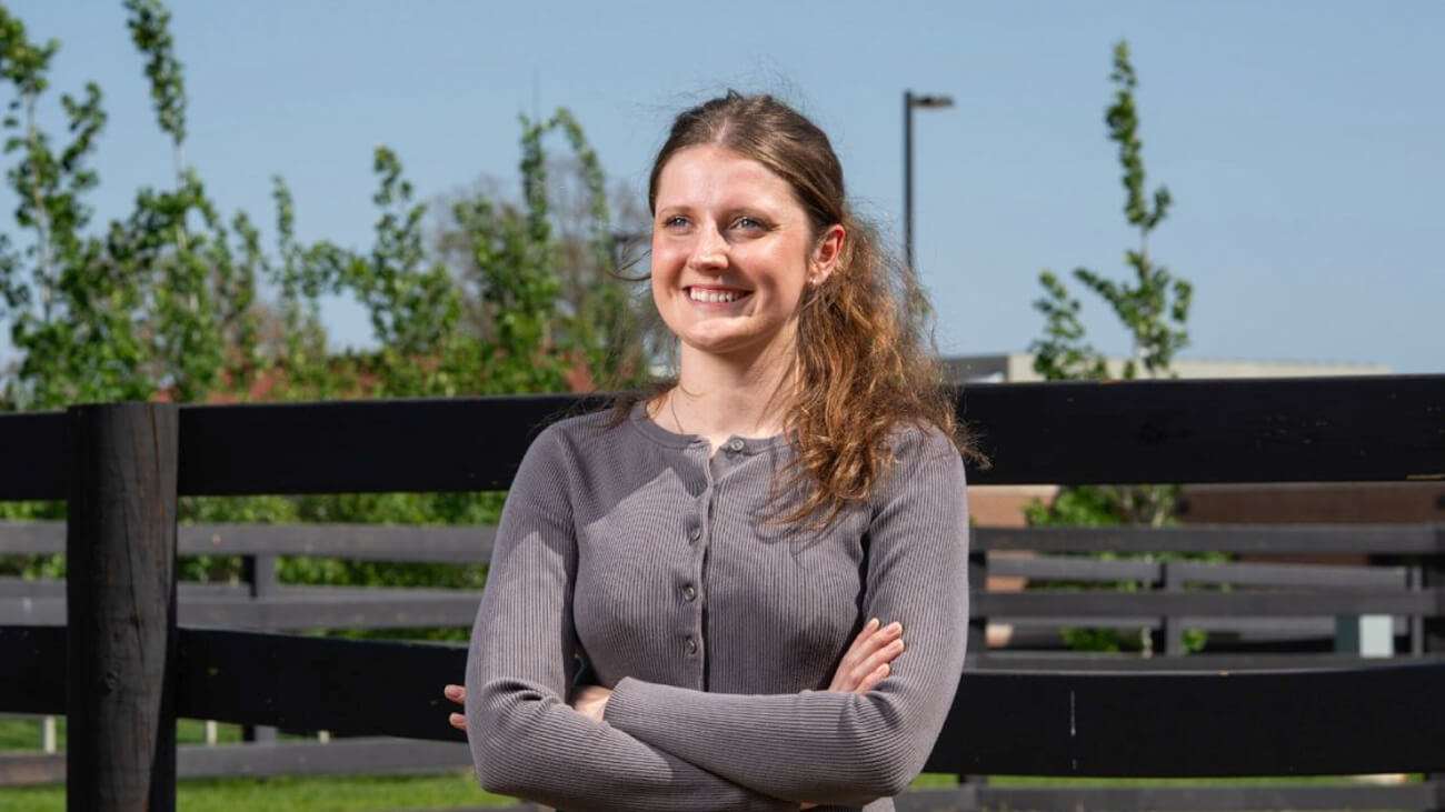 Mary Schultz, graduating senior in the landscape architecture program, standing outside the Purdue Veterinary Hospital